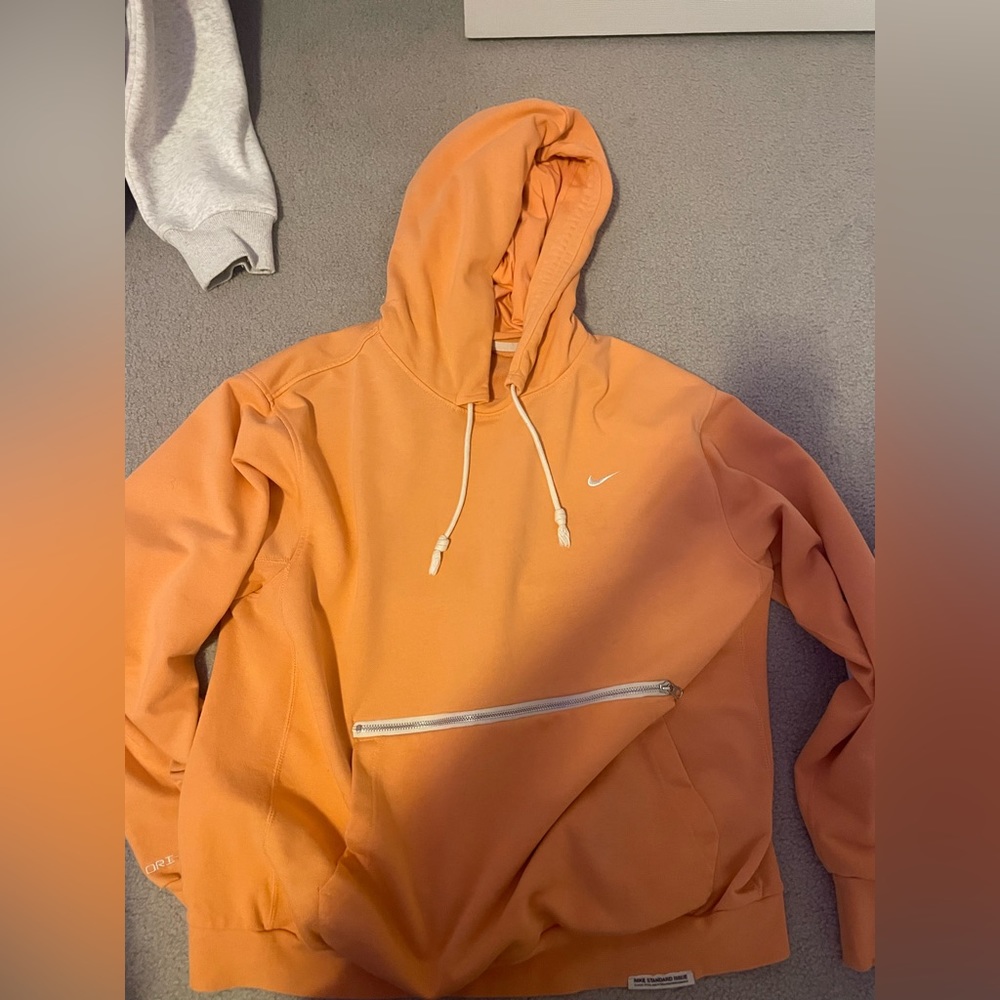 Orange Nike Dri-fit hoodie with zipper pocket